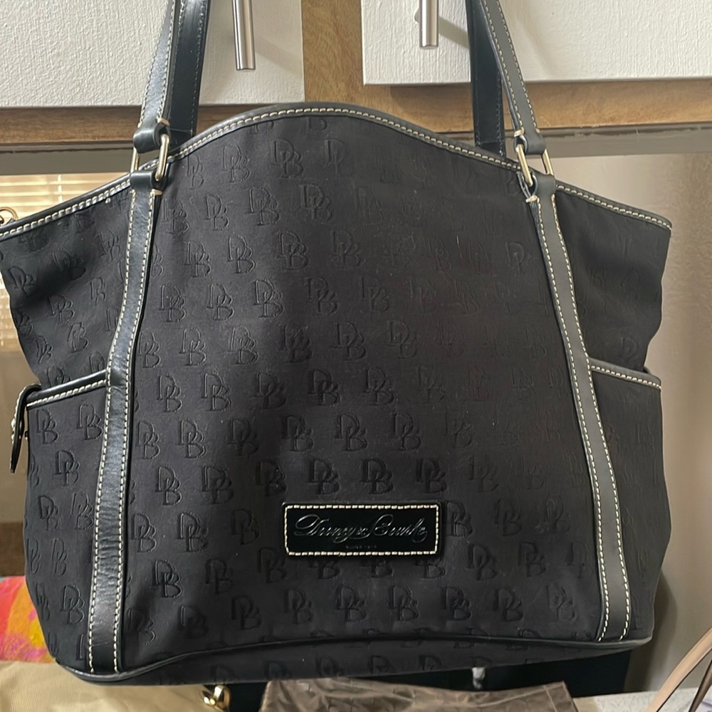 Black Dooney purse has lots of life left .. very spacious with no rips..